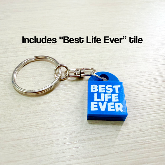 Blue keychain with 'Best Life Ever' text on a textured surface