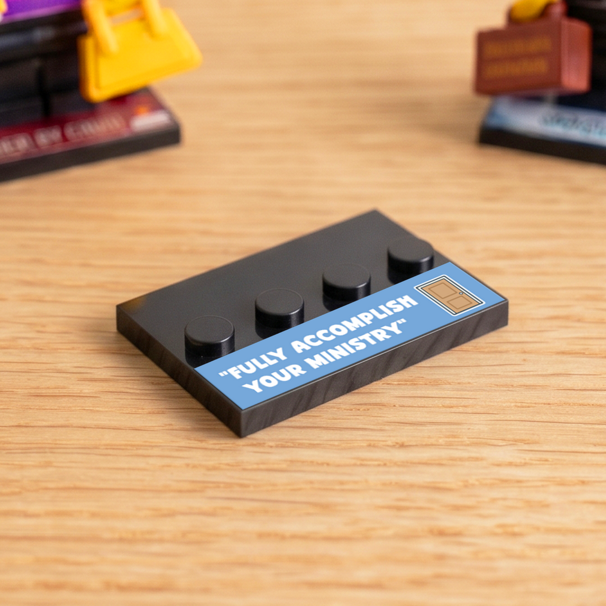 Black brick figure display stand with a blue 'Fully Accomplish Your Ministry' decal