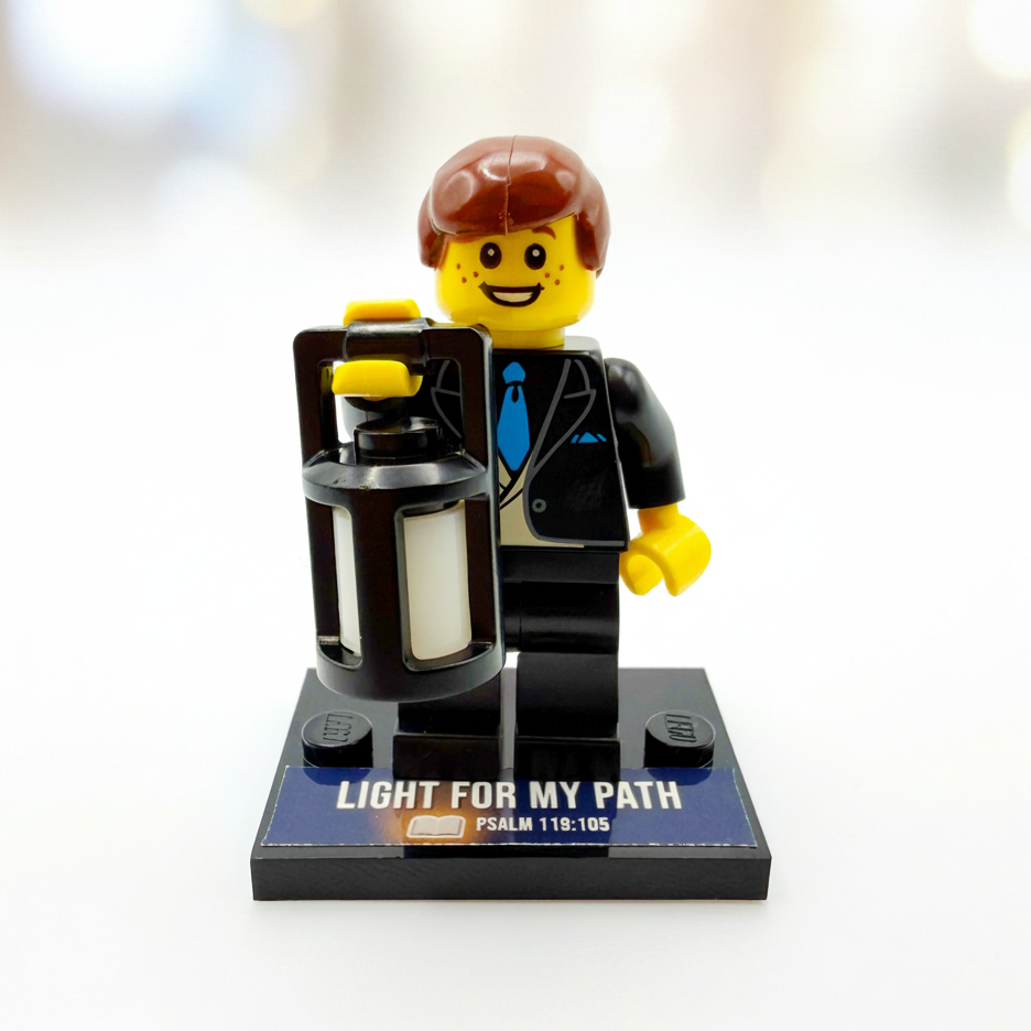 Brick figure with a suitcase and 'Light for My Path' text on a white background