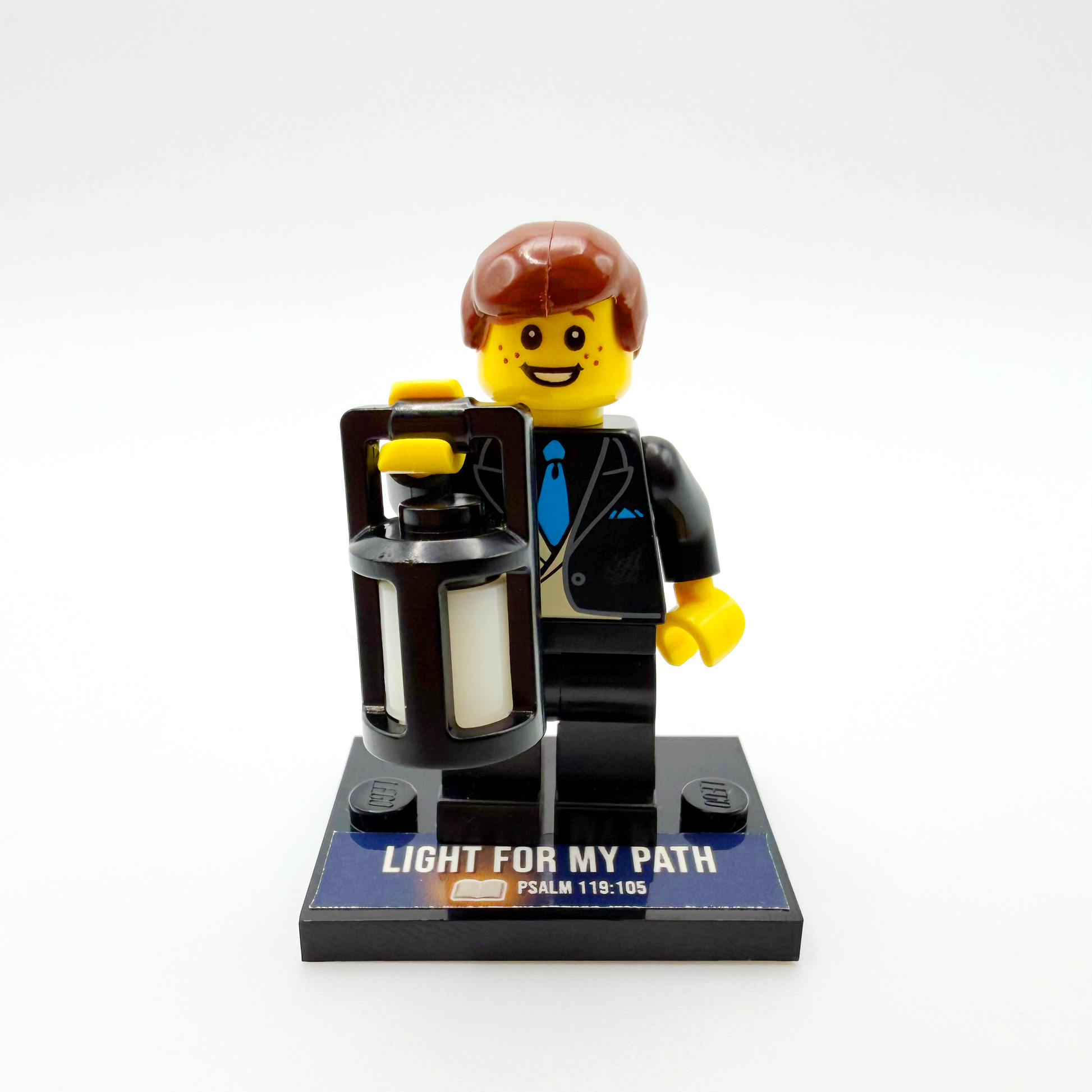 Brick figure with a suitcase and 'Light for My Path' text on a white background