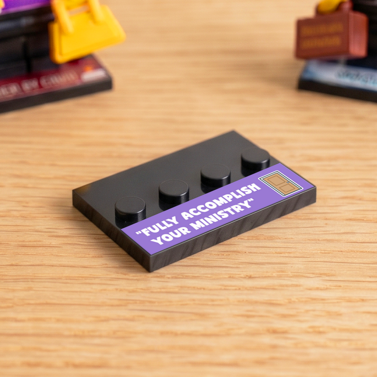 Black brick figure display stand with a purple 'Fully Accomplish Your Ministry' decal