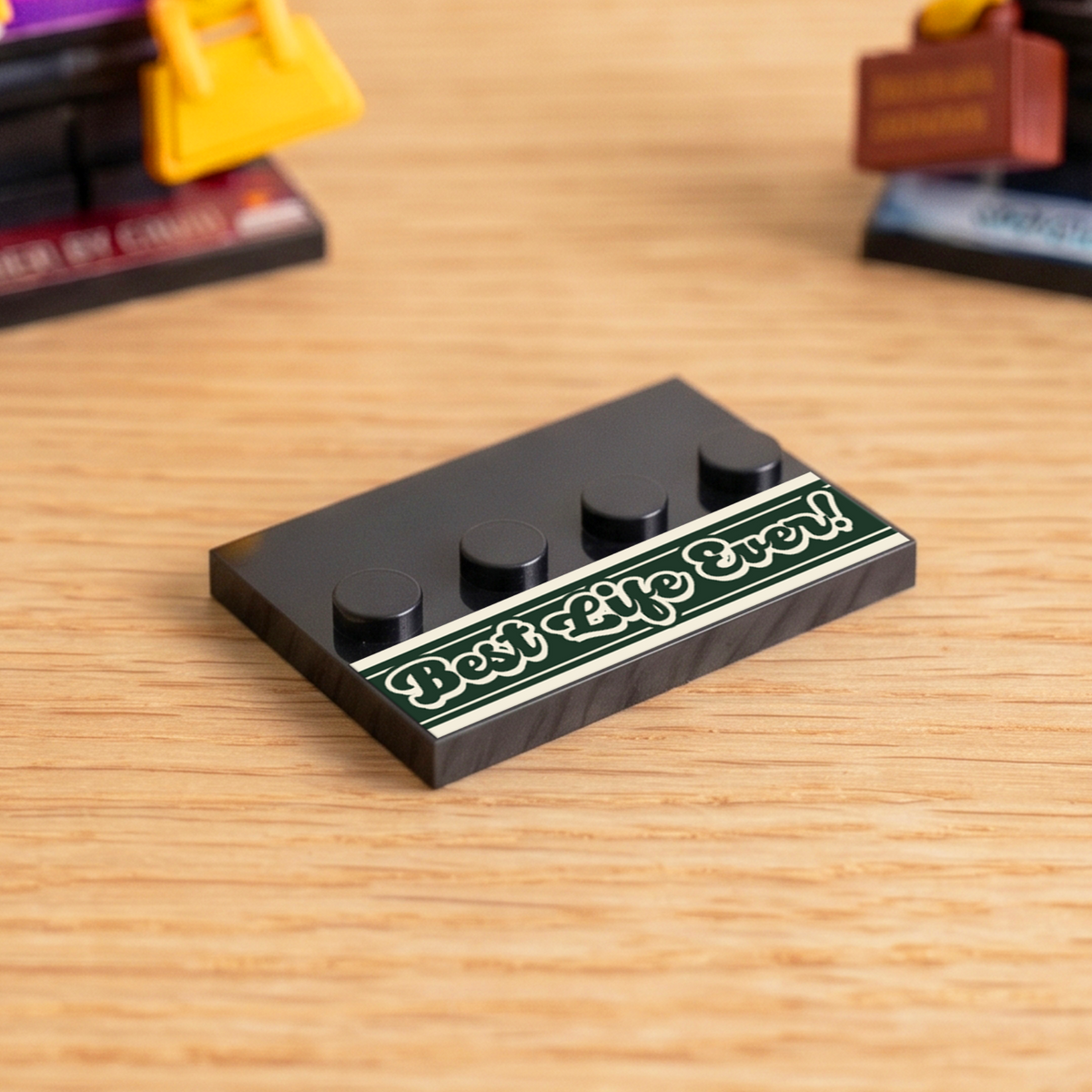 Black brick figure display stand with a retro-style 'Best Life Ever' decal